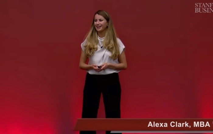 Alexa speaking on stage at Stanford Graduate School of Business